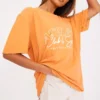 PRETTYLITTLETHING Orange Washed Athlete Print T Shirt