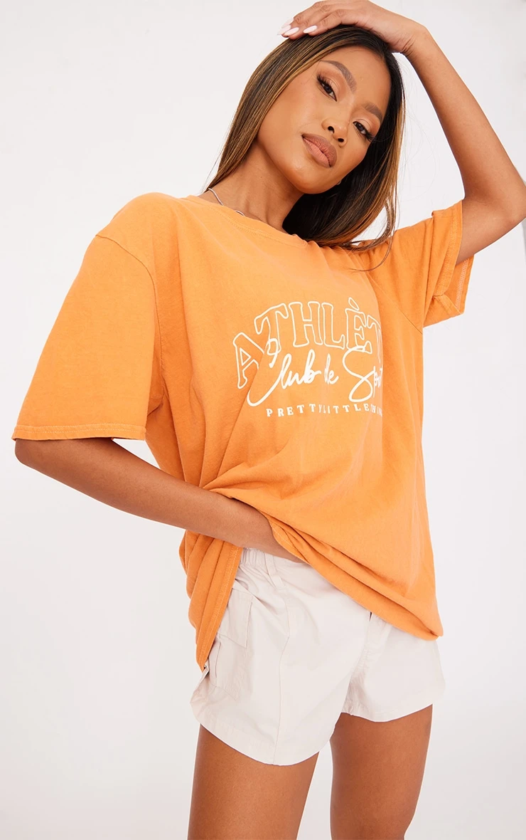 PRETTYLITTLETHING Orange Washed Athlete Print T Shirt 1 PRETTYLITTLETHING Orange Washed Athlete Print T Shirt